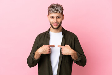 Young handsome caucasian man isolated on pink background with surprise facial expression