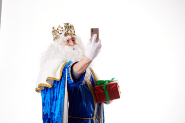 Magician King using a mobile phone on a white background