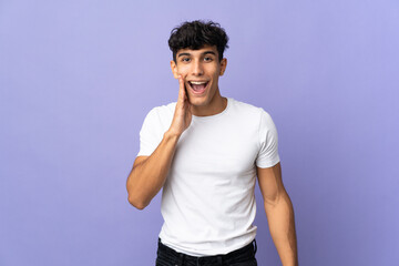 Young Argentinian man isolated on background with surprise and shocked facial expression