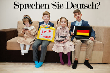 Four kids show inscription learn german. Foreign language learning concept. Sprechen sie Deutsch? - obrazy, fototapety, plakaty