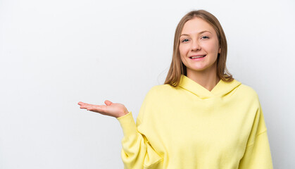 Young Russian woman isolated on white background holding copyspace imaginary on the palm to insert an ad