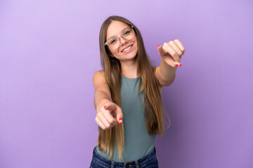 Fototapeta premium Young Lithuanian woman isolated on purple background pointing front with happy expression