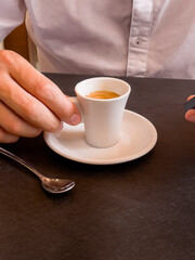 man's hands holding a coffee