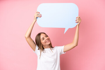 Young Lithuanian woman isolated on pink background holding an empty speech bubble