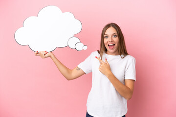 Young Lithuanian woman isolated on pink background holding a thinking speech bubble with surprised...