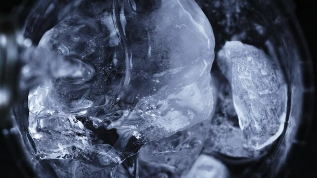 Super Slow Motion Detail Shot of Pouring Vodka on Ice Cubes at 1000 fps.