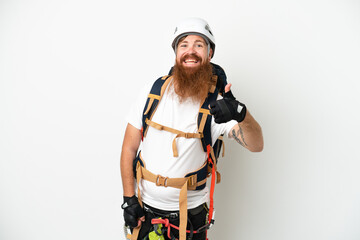 Fototapeta premium Young rock- climber reddish caucasian man isolated on white background with thumbs up because something good has happened