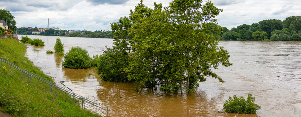 flood at city shows high water caused by heavy rainfalls making huge damaged and dirt because of...