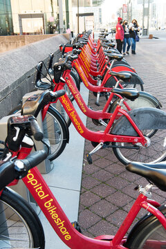 Red bikes stand in a row at the rental site