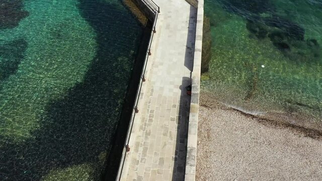 Kaiser Wilhelm's bridge and walkway a stone swim platform in Corfu, Greece