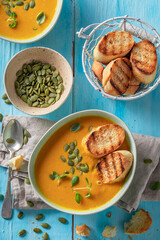 Creamy pumpkin soup with toasted bread and pumpkin seeds.