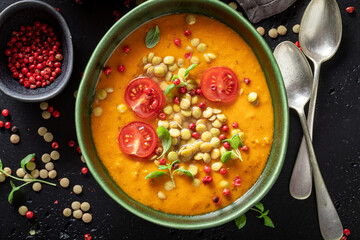 Healthy lentil soup with cherry tomatoes and cream.