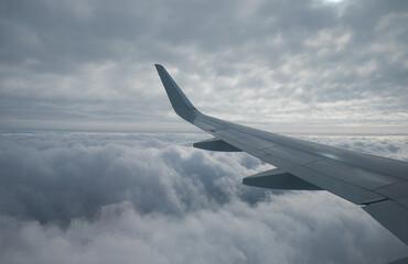 Obraz premium The cumulus clouds under the airplane window. Russia