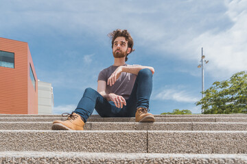 Fototapeta na wymiar bearded guy sitting on steps