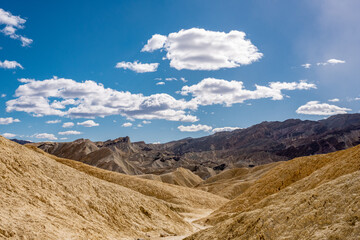 Person Standing On A Distant Hill In Golden Canyon