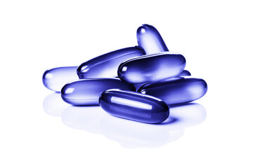 Close up of violet, purple soft gel capsules isolated on the white background