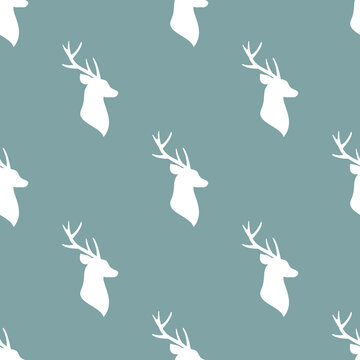 seamless winter pattern with white silhouette of deer head with antlers. vector flat Christmas ornament