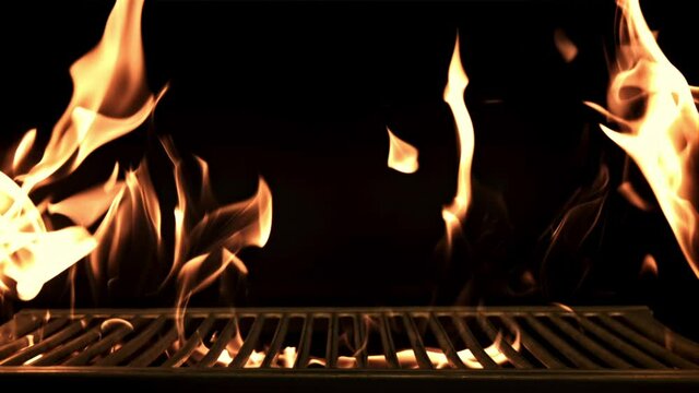 Grill with flames. On a black background. Filmed is slow motion 1000 frames per second. High quality FullHD footage