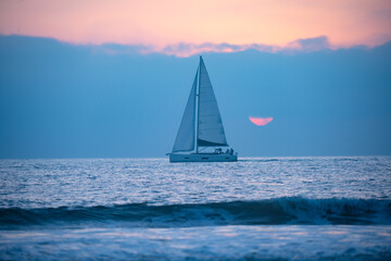 Fototapeta premium Sailing in the sunrise time with sailboat.