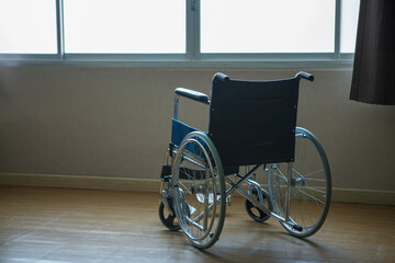 Fototapeta na wymiar Wheelchair by window in hospital feel lonely