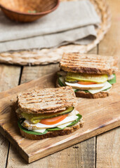whole grain grilled sandwich with gouda cheese, turkey ham, tomatoes and pickles