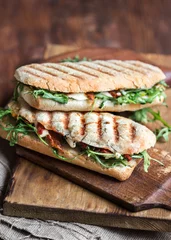Foto op Plexiglas italian grilled panini sandwich with dried tomatoes, mozzarella cheese and arugula © Generalnie