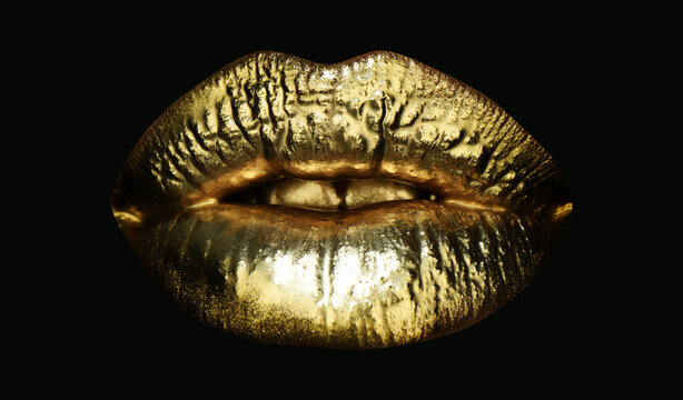 Gold lips. Gold paint from the mouth. Golden lips on woman mouth with make-up. Sensual and creative design for golden metallic. Golden make up. Isolated on black.