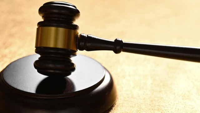 5 times slow motion of beating the Judge Gavel three times on gold background