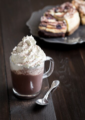 Hot chocolate with whipped cream in a dark moody setting