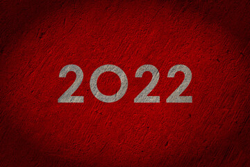 2022 numbers painted on red concrete wall
