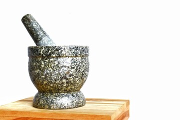 stone mortar and pestle on stone slab on white background stone mortar