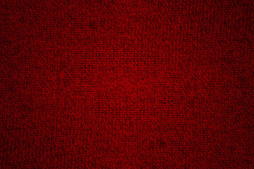 Fototapeta premium Red knitted wool fabric texture background with grunge