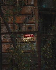 Attention sign on the wall of an old building