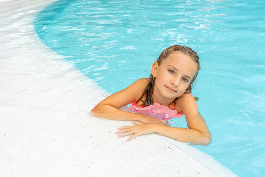 Beautiful little girl posing in the pool. Hight quality photo