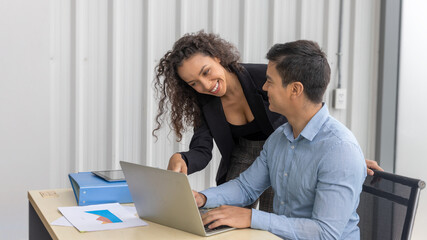 Two business office workers or managers discuss about market plan. Two colleagues exchange ideas to...