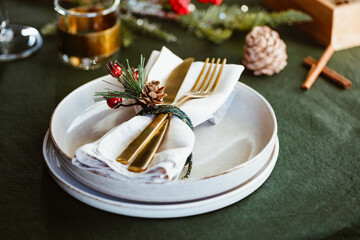 Festive table setting with winter decor. The concept of Thanksgiving or Christmas family dinner.