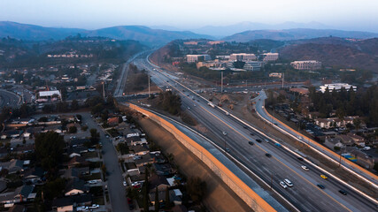 Obraz premium Sunset view of the 57 freeway as it passes through downtown Brea, California, USA.