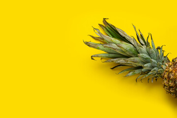 Fototapeta na wymiar Ripe pineapple on a yellow background. Top view, flat lay