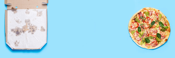 pizza and empty open pizza packaging on blue background. Top view, flat lay. Banner