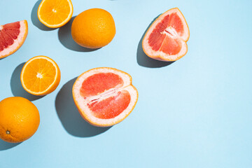 citrus fruits, oranges, grapefruit on a blue background. Top view, flat lay