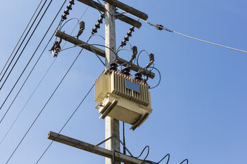 Electric transformer substation on blue sky background