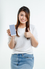 Portrait studio shot Asian young pretty female model in long sleeve shirt show naked shoulder and short denim skirt stand hold black blank screen smartphone for ads look at camera on white background