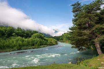 blue mountain river against the background of a snowy peak in Arkhyz