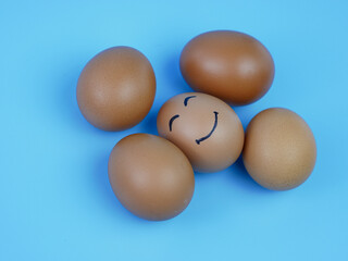 group of chicken eggs, one of which is a smiling face. the concept of innovation and leadership.