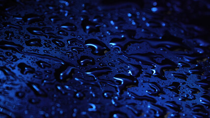 Picture of liquid drops on dark blue glass