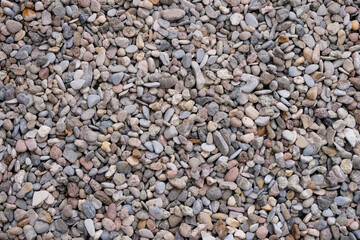 Colored small pebbles of gray, pink, and beige color for design.