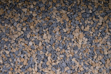 Granite crushed stones for garden design. The mix of gray and beige stones. 	