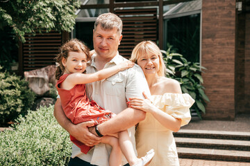 Portrait of happy family on summer day at hotel on vacation. Weekend. Full family.Happy...