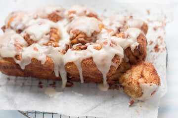 Monkey yeast bread with cinnamon and pecans, vanilla icing - 475663161