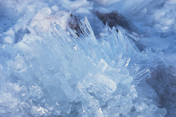 Blocks of river ice in spring. Fast melting. Ice texture on a spring day under the sun. Amur river. Ice needles.